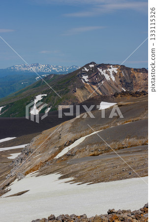 View of snow-capped Mount Biei and its crater topography from the Tokachidake hiking trail in Hokkaido's 100 famous mountains View of snow-capped Mount Biei and its crater topography from the Tokachidake hiking trail in Hokkaido's 100 famous mountains 133115326