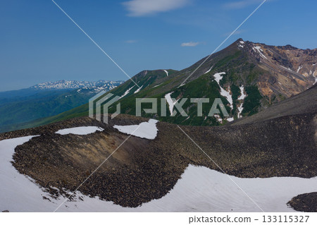 View of snow-capped Mount Biei and its crater topography from the Tokachidake hiking trail in Hokkaido's 100 famous mountains View of snow-capped Mount Biei and its crater topography from the Tokachidake hiking trail in Hokkaido's 100 famous mountains 133115327