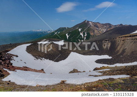 View of snow-capped Mount Biei and its crater topography from the Tokachidake hiking trail in Hokkaido's 100 famous mountains View of snow-capped Mount Biei and its crater topography from the Tokachidake hiking trail in Hokkaido's 100 famous mountains 133115328