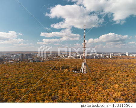 Aerial tv tower in autumn forest with epic sky 133115503