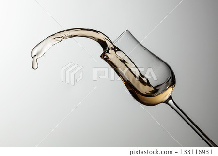 The drink spills out of the glass. 133116931