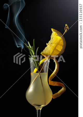 Limoncello garnished with a steaming rosemary branch. Limoncello garnished with a steaming rosemary branch. 133116937