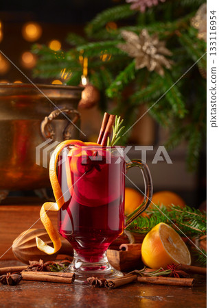 Christmas mulled wine with spices, citrus, and vintage kitchen utensils. 133116954
