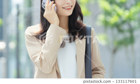 Woman/businesswoman walking in an office district Woman/businesswoman walking in an office district 133117601