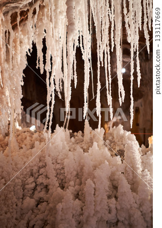 Stunning view inside a salt mine, showcasing unique formations of salt stalactites and stalagmites, creating a surreal, natural landscape. Stunning view inside a salt mine, showcasing unique formations of salt stalactites and stalagmites, creating a surreal, natural landscape. 133117669
