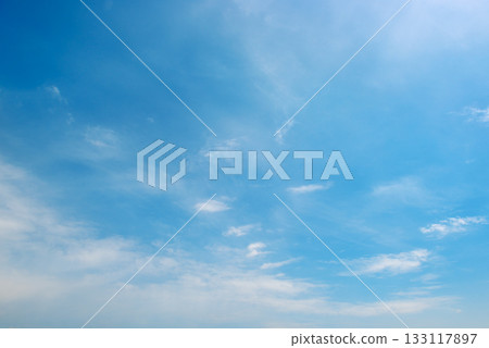 Blue sky filled with various cloud formations including cumulus and wispy types arranged in layered composition with copy space 133117897
