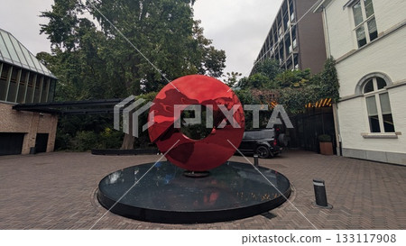 A metallic red object on the water in Antwerp 133117908