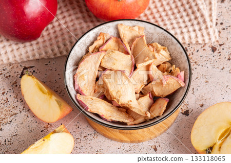 Healthy apple dried snack in ceramic bowl on sunny kitchen 133118065