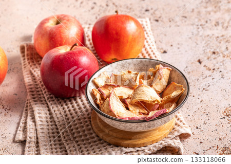 Dried apple slices in a ceramic bowl on the kitchen table Dried apple slices in a ceramic bowl on the kitchen table 133118066