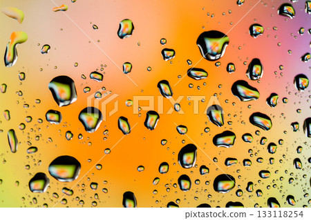 Beautiful multi-colored water droplets on a glass Beautiful multi-colored water droplets on a glass 133118254