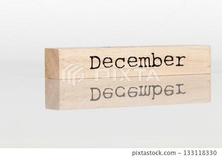 a wooden cube with an inscription December on a white background 133118330
