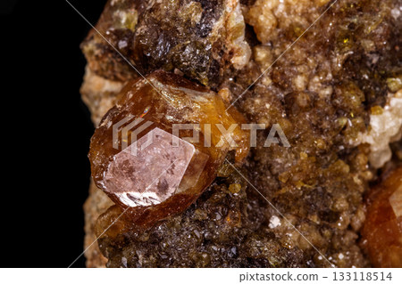 macro mineral stone Grossular, Garnet, Epidote on a black background 133118514