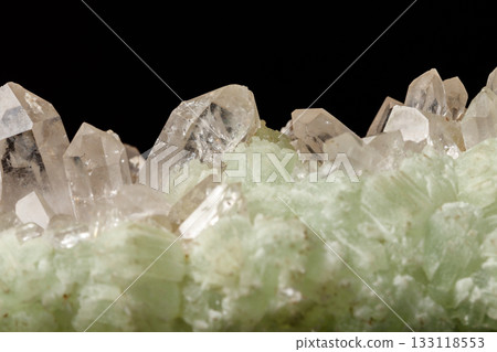 Macro mineral stone Prehnite quartz on a black background 133118553