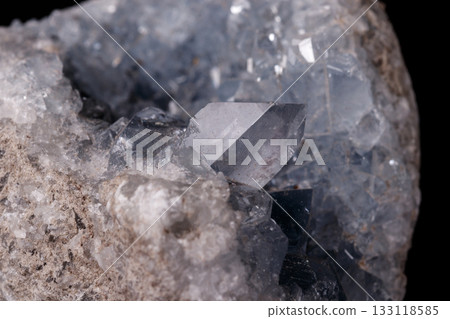 Celestine mineral stone macro on microcline on black background Celestine mineral stone macro on microcline on black background 133118585