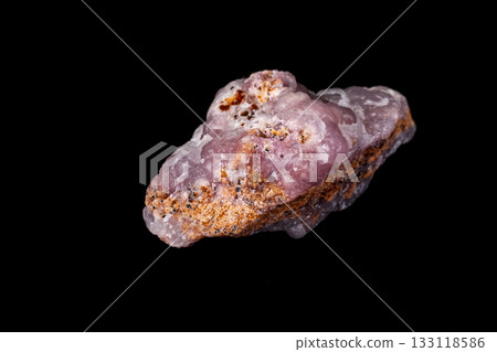 Macro pink Smithsonite mineral stone on microcline on black background Macro pink Smithsonite mineral stone on microcline on black background 133118586