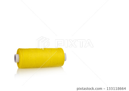 skein of thread yellow colors macro on a white background 133118664