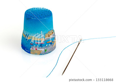 thimble and needle and thread on a white background thimble and needle and thread on a white background 133118668