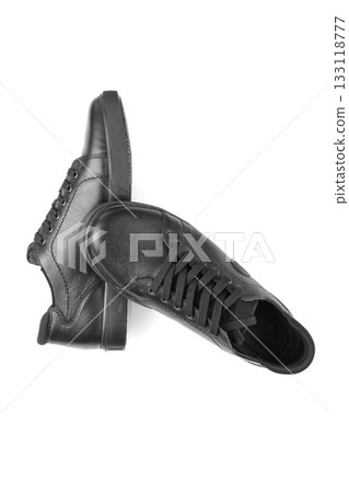 black leather sneakers on a white background black leather sneakers on a white background 133118777