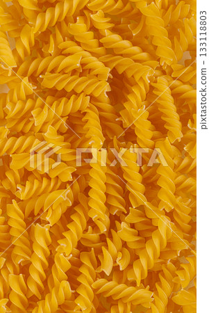 Pasta products in the form of a spiral, texture, on a white background Pasta products in the form of a spiral, texture, on a white background 133118803