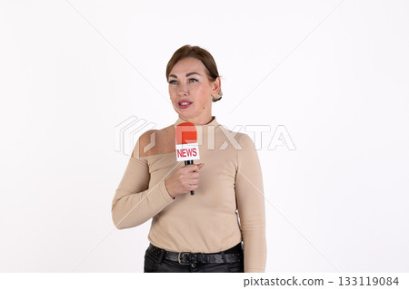The reporter is holding a microphone and speaking 133119084