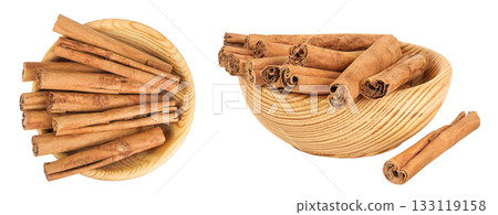 Cinnamon sticks in wooden bowl isolated on white background with full depth of field. Top view. Flat lay. 133119158