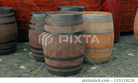 Rustic wooden barrels displayed outdoors in a historic setting Rustic wooden barrels displayed outdoors in a historic setting 133119226