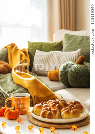 Autumn Table Setting with Pumpkin-Shaped buns with Cinnamon, Apples, Pumpkins, and Cozy Decor 133119340