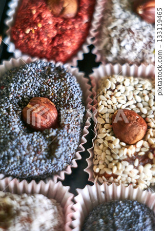 A gift set of dried fruit chocolates with hazelnuts. A handmade, raw dessert. Selective focus A gift set of dried fruit chocolates with hazelnuts. A handmade, raw dessert. Selective focus 133119465