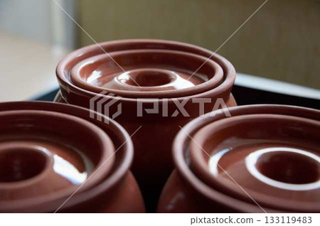 Close-up of upturned clay baking pot lids. Close-up of empty clay pots. Close-up of upturned clay baking pot lids. Close-up of empty clay pots. 133119483