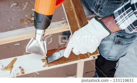 Carpenter at work, restoring an old wooden window. Carpentry. 133119631
