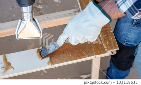 Carpenter at work, restoring an old wooden window. Carpentry. 133119633
