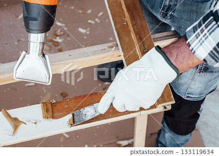 Carpenter at work, restoring an old wooden window. Carpentry. Carpenter at work, restoring an old wooden window. Carpentry. 133119634