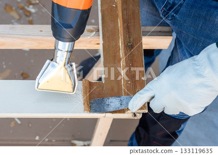 Carpenter at work, restoring an old wooden window. Carpentry. 133119635