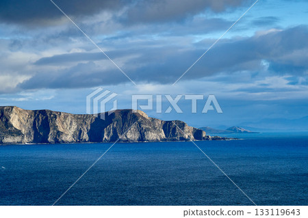 View over the ocean in cloudy blue sky weather with Achill island, Keel vilage and beach 133119643