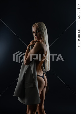 Model in studio with dramatic lighting, long hair, and elegance 133120122