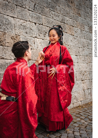 Couple celebrating wedding in traditional Chinese clothing Couple celebrating wedding in traditional Chinese clothing 133120214