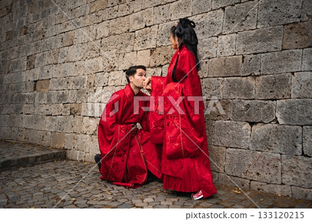 Intercultural couple celebrating wedding in traditional Chinese clothing 133120215