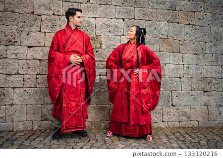 Interracial couple celebrating traditional Chinese wedding ceremony Interracial couple celebrating traditional Chinese wedding ceremony 133120216