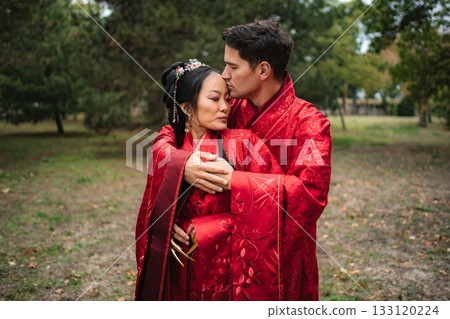Loving interracial couple celebrating traditional Chinese wedding ceremony Loving interracial couple celebrating traditional Chinese wedding ceremony 133120224