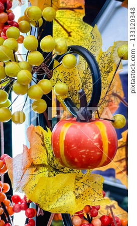 Vibrant fall still life with a decorative pumpkin, yellow berries, and colorful autumn foliage Vibrant fall still life with a decorative pumpkin, yellow berries, and colorful autumn foliage 133120348
