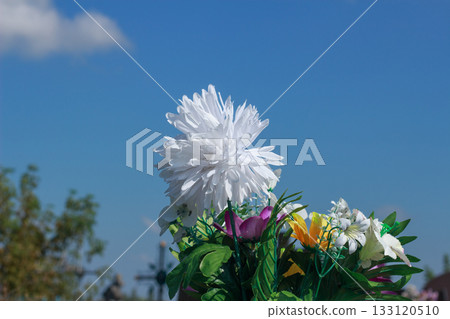 White Artificial Flower Bouquet Against Blue Sky 133120510