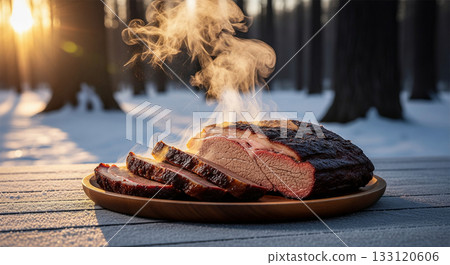 Beef brisket, perfectly sliced and steaming, rests on a wooden platter in a serene forest clearing. The dark crust gives a rich look against the snowy background at dusk. 133120606