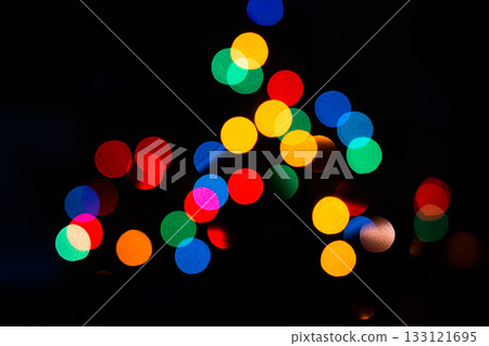 Colorful sparkling and defocused lights on dark background. Christmas theme. Abstract bokeh wallpaper. Colorful sparkling and defocused lights on dark background. Christmas theme. Abstract bokeh wallpaper. 133121695