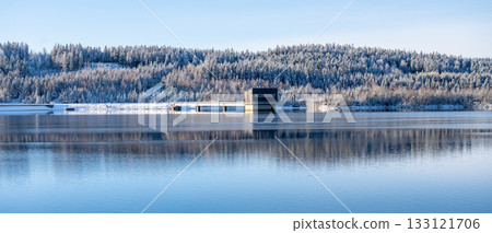 Spruce forests of Jizera Mountains reflected in Josefuv Dul Dam on sunny winter day, Czech Republic Spruce forests of Jizera Mountains reflected in Josefuv Dul Dam on sunny winter day, Czech Republic 133121706