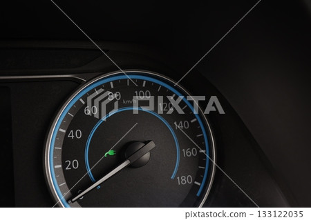 A green light indicating that an electric car is charging. Speedometer. A green light indicating that an electric car is charging. Speedometer. 133122035