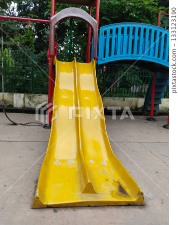 Colorful childrens playground set with slides, bridge, climbing stairs, swings and canopies in public park, designed for kids recreation, fun and physical activity in a safe and vibrant outdoor Colorful childrens playground set with slides, bridge, climbing stairs, swings and canopies in public park, designed for kids recreation, fun and physical activity in a safe and vibrant outdoor 133123190