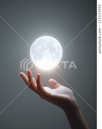 Hand holds a glowing orb that appears to float in midair, creating a mystical atmosphere in a dimly lit space Hand holds a glowing orb that appears to float in midair, creating a mystical atmosphere in a dimly lit space 133123455