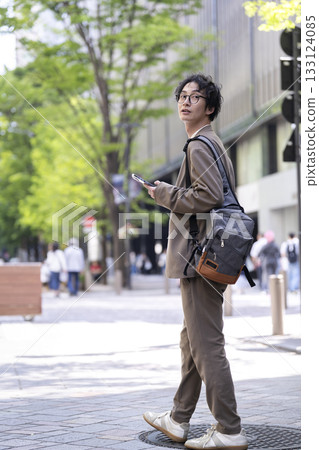 一名30多歲的男子在城裡散步 133124085