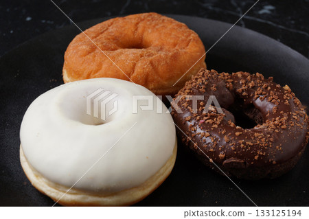 Chocolate donuts and white chocolate donuts Chocolate donuts and white chocolate donuts 133125194