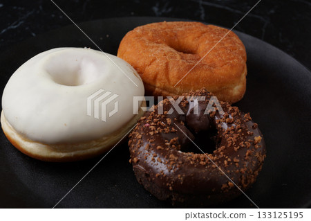 Chocolate donuts and white chocolate donuts 133125195